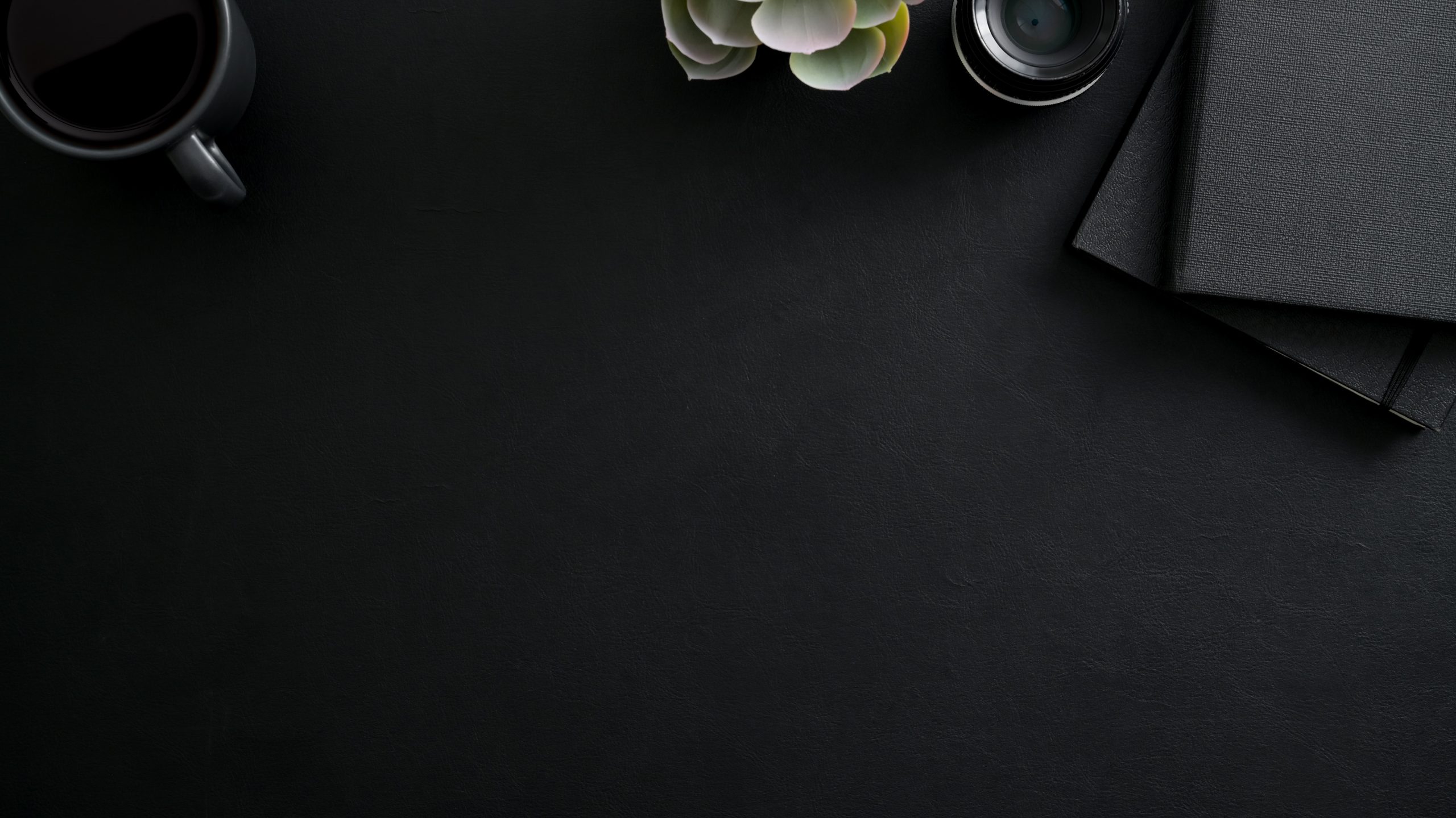 black-coffee-cup-and-black-notepad-on-black-table-3815759